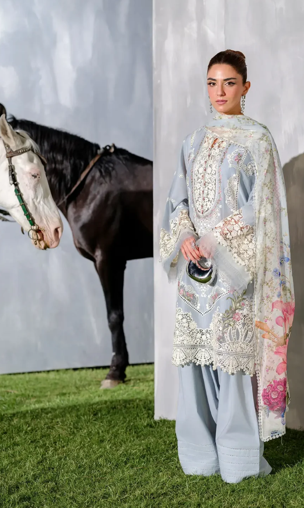 Woman in traditional outfit with horse in the background